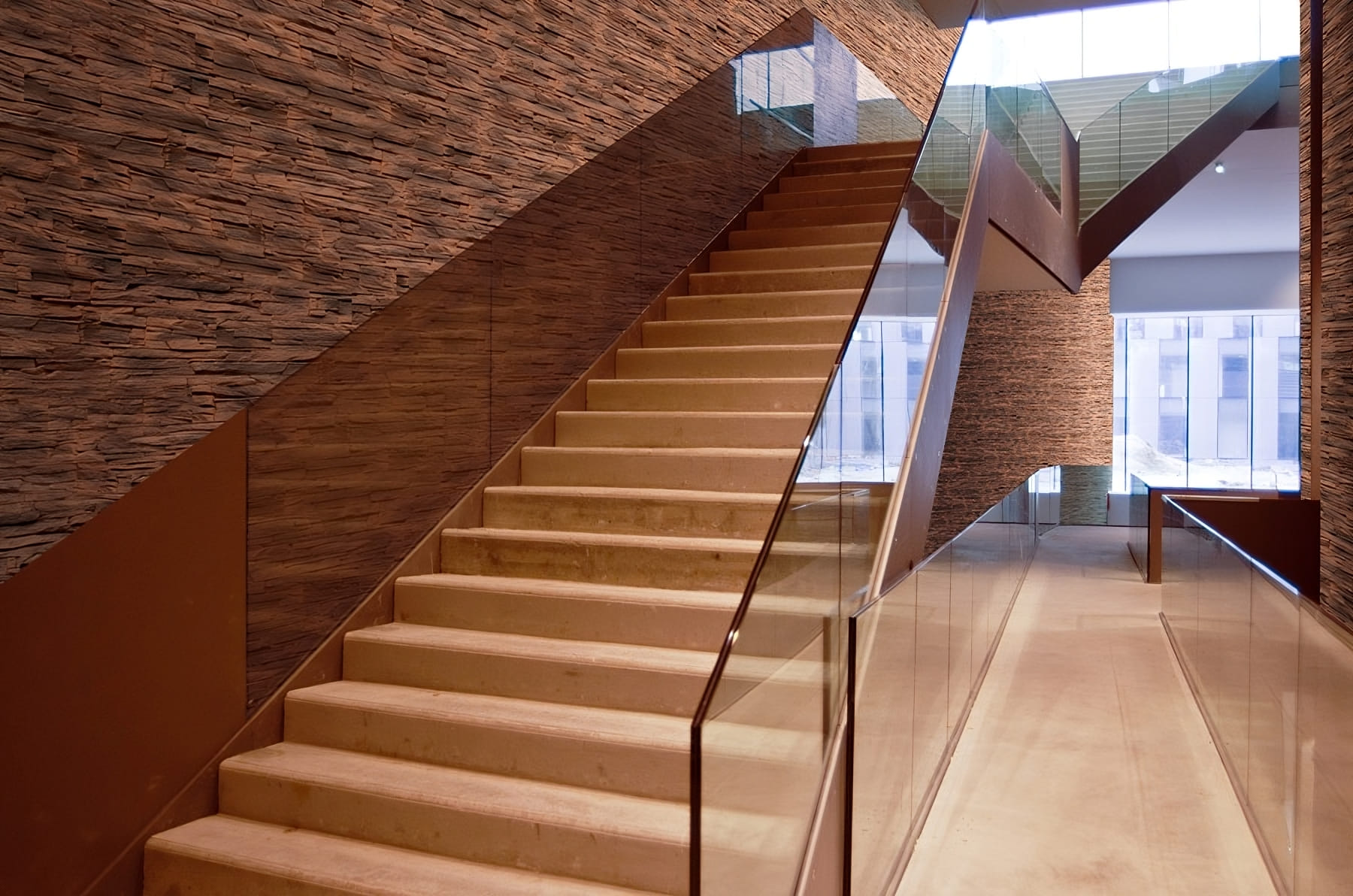 Walls decorated with artificial stone tiles behind the staircase inside the building